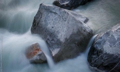 High water flowing over large granite boulders, South Yuba River, CA